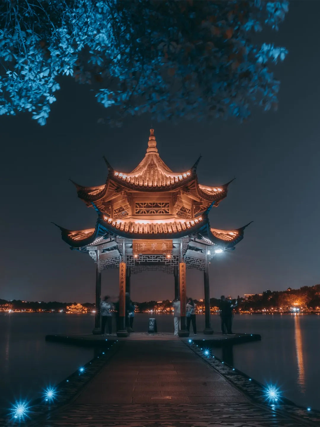 Hangzhou West Lake night view with city lights reflection