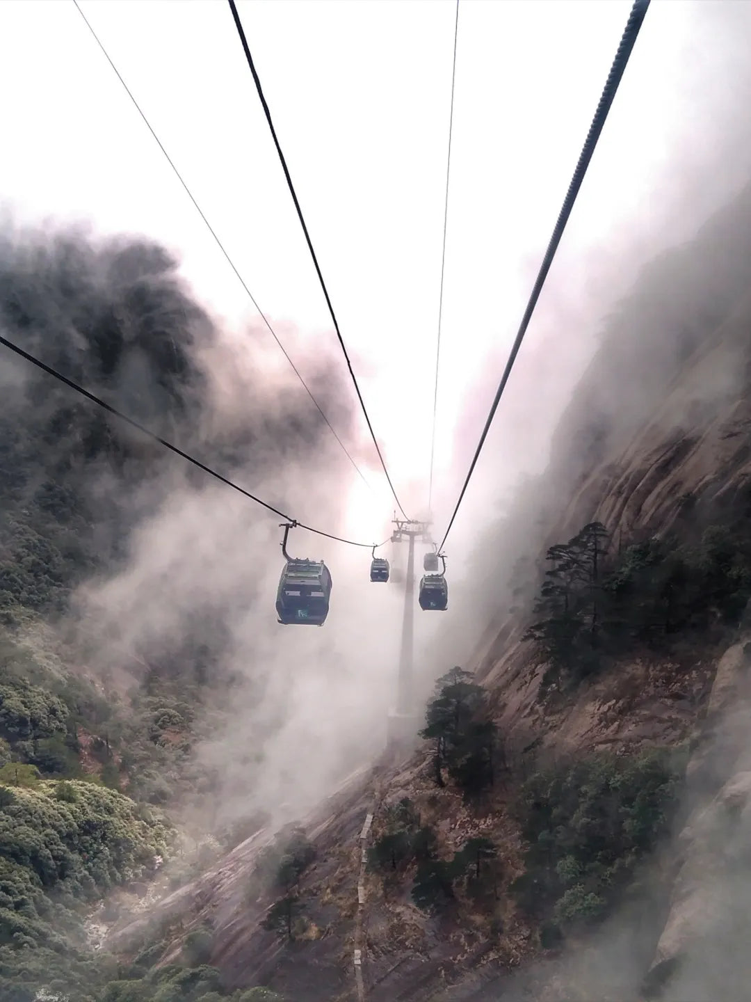 Huangshan cable car moving through clouds