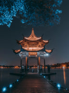 Hangzhou West Lake night view with city lights reflection