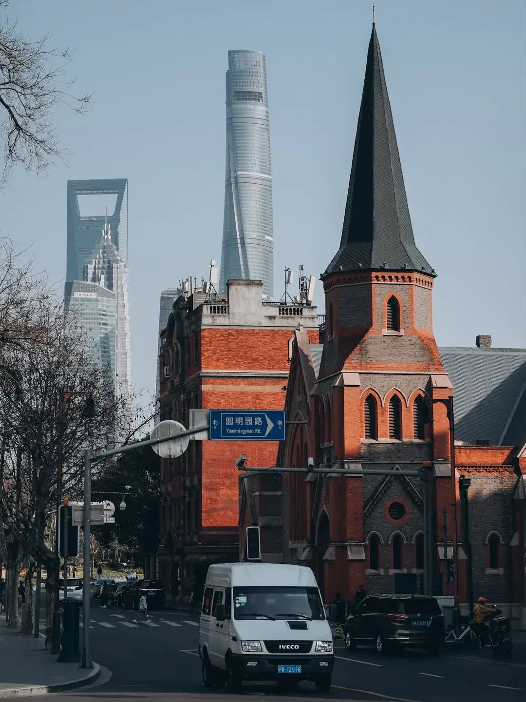 Shanghai Tower in winter haze,skyscraper top piercing through clouds